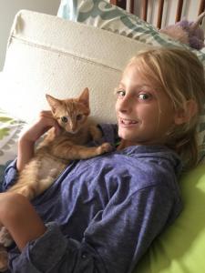 Doing well after surgery, Minnie snuggles with Amy's daughter