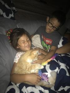 Peyton enjoys some snuggles and fun with her new forever family.